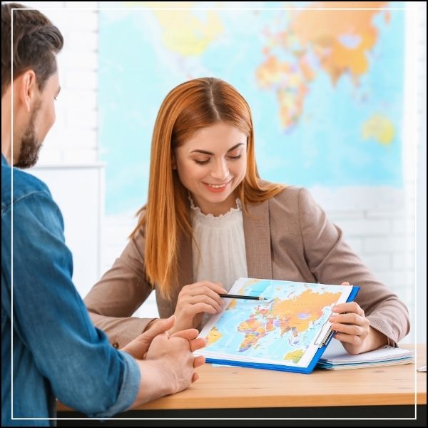 Hospitality and Tourism manager showing a world map to a customer.